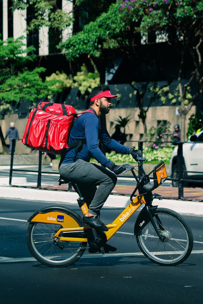Cyclist delivering food on a city street, showcasing urban delivery services.